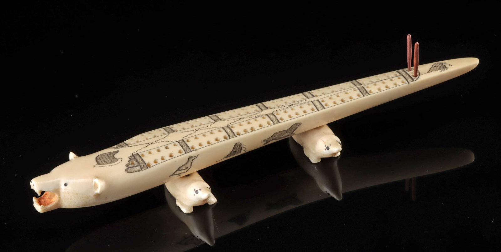 Early 20th C. Inuit Walrus Ivory Cribbage Board: Native American, Northwestern United States, Alaska, Inuit or Inupiaq, ca. early 20th century CE. A wonderful cribbage board, hand-carved from the tusk of a walrus to reflect the form of a polar bear 
