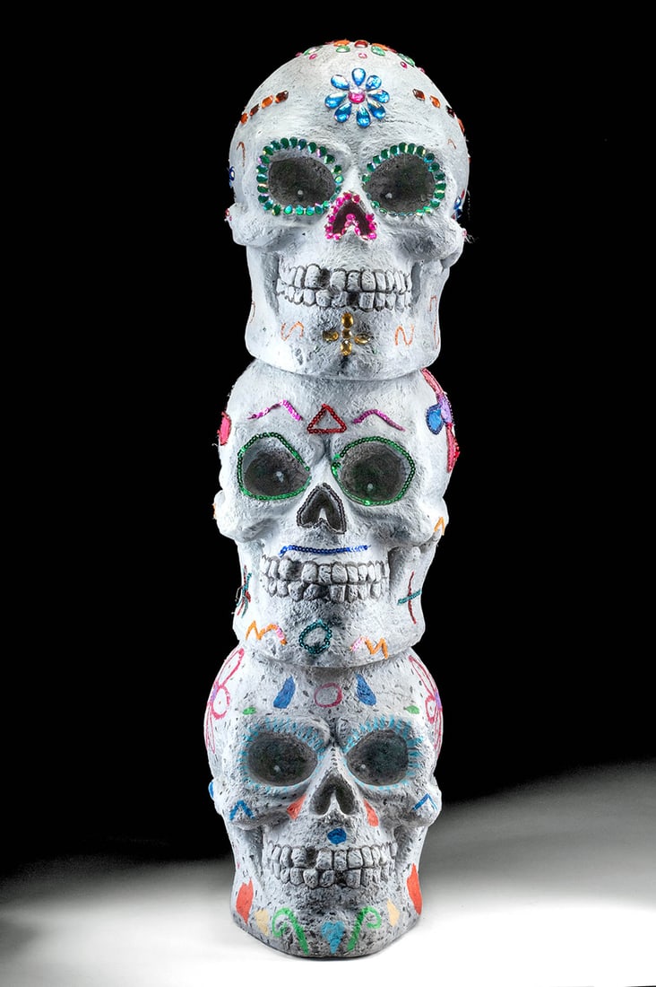 21st C. Mexican Plaster Dios de los Muertos Skulls: **Originally Listed At $100** Latin America, Mexico, ca. 21st century CE. A festive plaster sculpture depicting a trio of stacked calaveras or sugar skulls, bedazzled with sequins, plastic gems, vibra