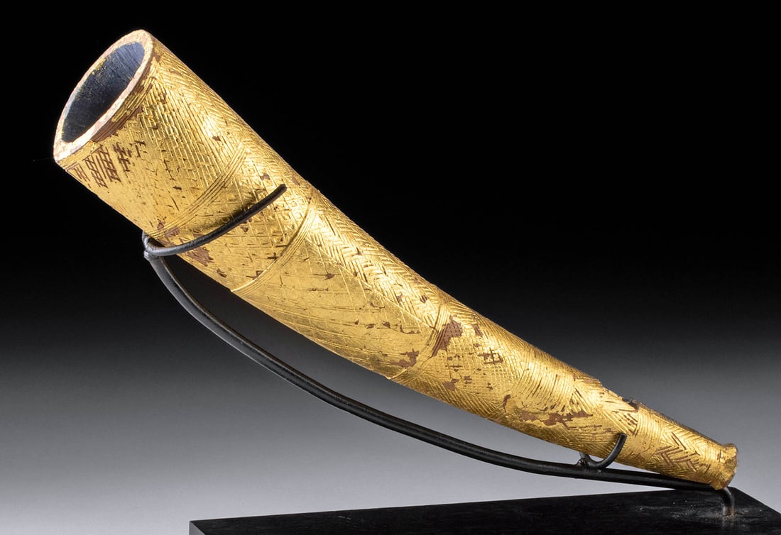 Museum-Exhibited African Akan Gilded Aben (Trumpet): West Africa, Ghana / Cote d'Ivoire, Akan, ca. 19th to early 20th century CE. A gold leaf-covered carved wood trumpet instrument known as an aben, modeled like a cow's horn or elephant's tusk, tapering