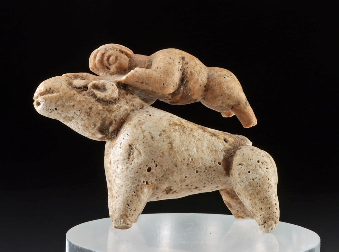 Indus Valley Sculpture - Human Riding Quadruped: Ancient Central Asia, Indus Valley, Harappan / Mohenjo-Daro civilization, ca. 2700 to 2000 BCE. A hand-carved bone figure depicting a stylized human grasping the top of a large quadruped's head, perha