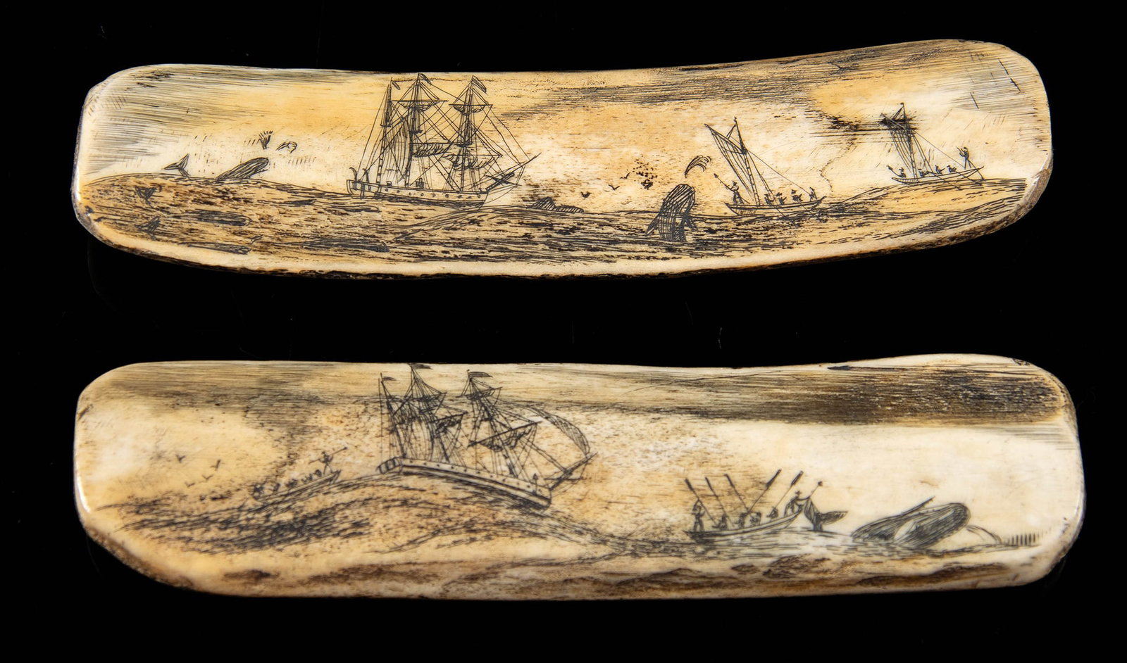 Two 19th C. Scrimshawed Rib Bones w/ Whaling Motifs: North America, United States, ca. 19th century CE. A pair of scrimshaw whale rib bones with scenes of whaling vessels and whales etched into both sides. There are fully rigged sailing ships with the s
