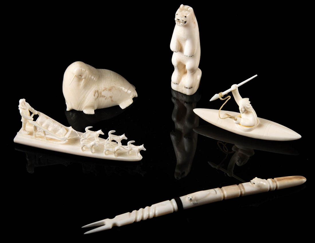 5 Miniature Inuit Walrus Ivory Carvings & Fork: Native American / First Nations, Northwestern United States or Canada, Inuit, ca. mid-20th to 21st century CE. A collection of 5 walrus tusk ivory carvings: a bear and walrus figurine, a dog sled, a h