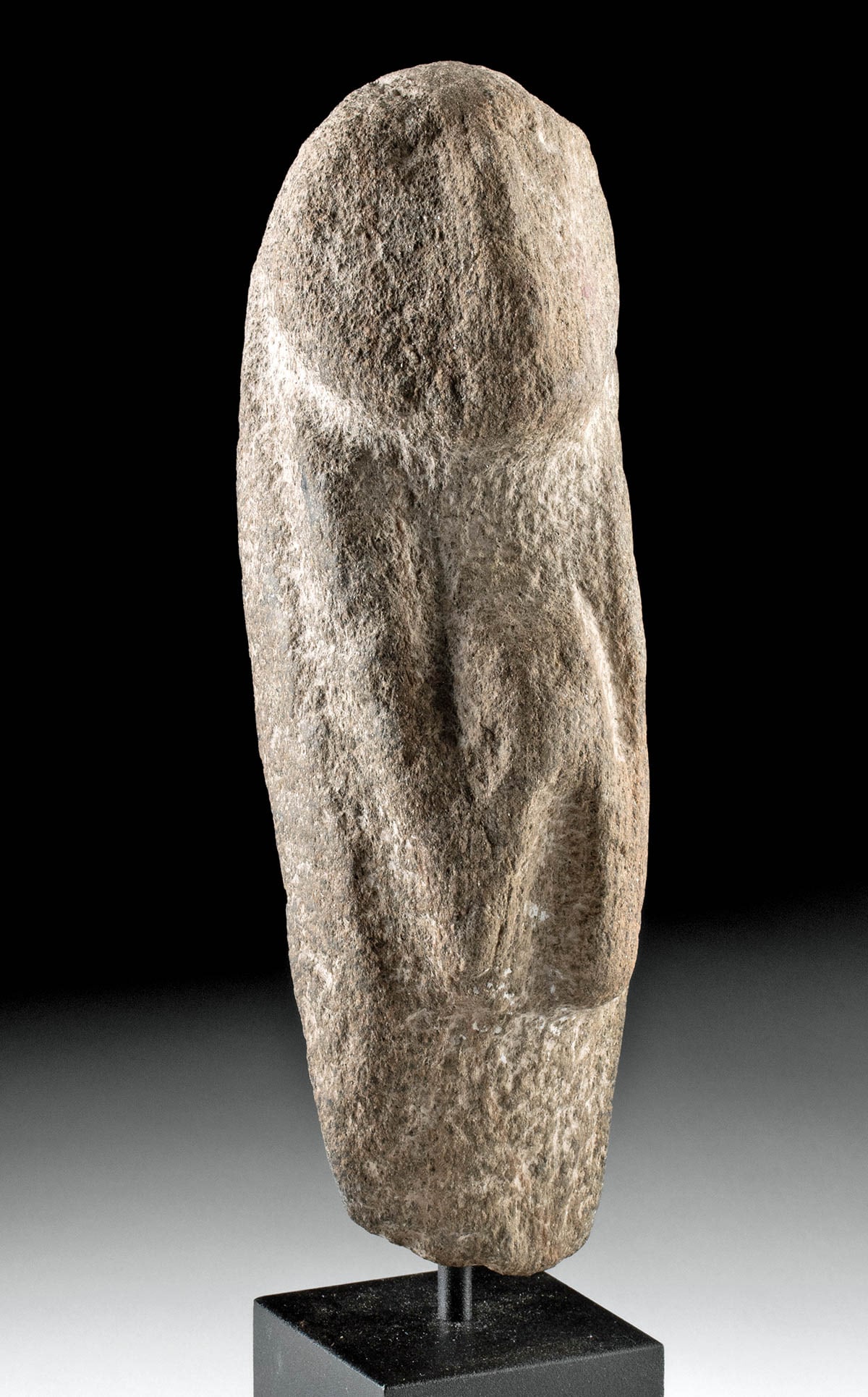 Rare Neolithic Peruvian Stone Venus Figure: Pre-Columbian, Peru, Neolithic Period, ca. 10000 to 5000 BCE. An extremely rare Peruvian Venus figure exhibiting a highly stylized form amidst the naturally mottled brown, gray, and beige hues of the