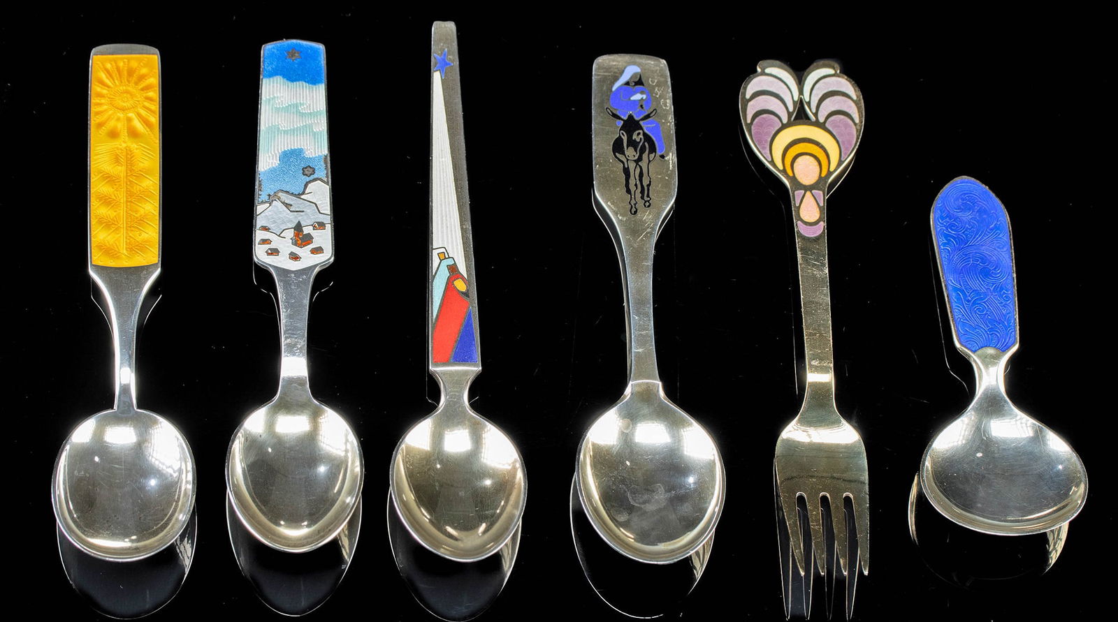 European Enameled Silver Christmas Spoons (6): **Originally Listed At $400** Northern Europe, Denmark & Norway, ca. mid-20th century CE. Five collectible Christmas spoons from Anton Michelsen of Denmark of vermeil silver and enamel, and a single s