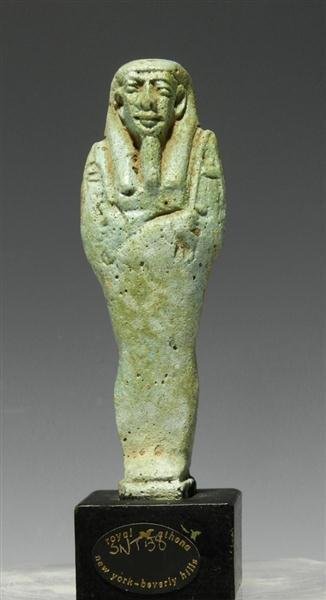 An Egyptian Faience Ushabti, ex-Royal Athena: Egypt, Late Dynastic, Ca 662 to 300 BC. Standing mummiform figure ready to work for the deceased in the afterlife, holding crook and flail. Deep clear features and museum accession number on base and