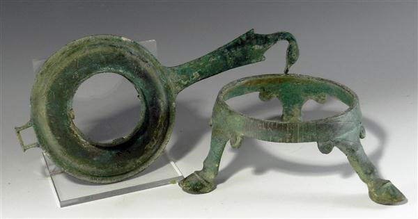 A Roman Bronze Strainer and Stand: Rome, Ca. 30 BC - 250 AD. Ancient kitchenware! The strainer's handle terminates with a goose's head, very similar to one found in the Royal Ontario Museum of Archaeology, while the bronze tripod's fee