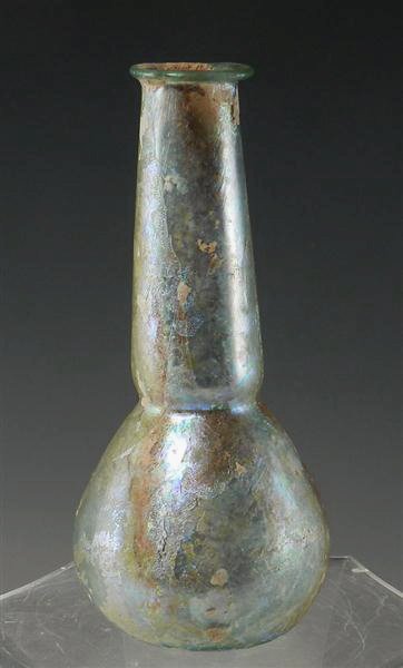 A Roman Glass Unguent / Bottle: Rome, Ca. 2nd Century CE. Large, globular base and cylindrical stem which tapers to a flat rim. 6-1/2"T x 3"W. Provenance: Ex-Prominent New York City, NY Gallery. Authenticity Guaranteed The starting 