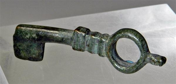 A Roman Bronze Key, Rare Shape, Superb Patina: Rome, ca. 1st-3rd Century AD. Key rings like this were once used to lock and unlock treasures, maybe a chest full of denarii, or perhaps a trunk filled with Egyptian Scarabs. Solid bronze. 2-3/4"L. Pr