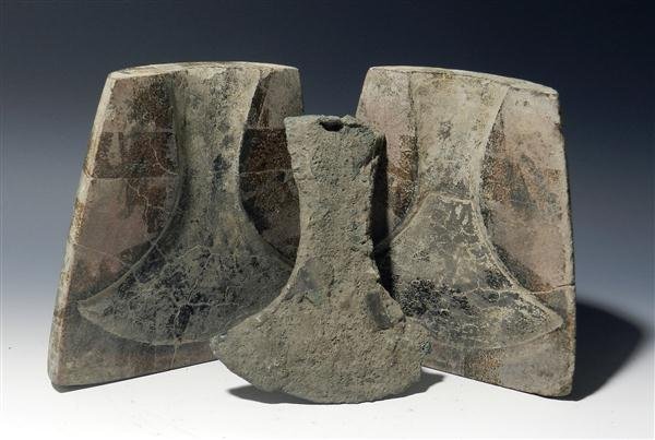 A Ban Chiang Bi-Valve Axe Mold and Axe Blade: Southeast Asia (Cambodia, Thailand), Ban Chaing, ca. 4th to 2nd Century B.C. Bivalve stone mould and axe blade. Ban Chiang smiths used this to mould spearheads and bronze axes before beating to increa