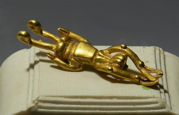 A Calima Gold Grasshopper Pendant, 14.4g: Pre-Columbian, Colombia, Ca. 200 BC - 200 AD. Grasshopper is depicted with incised details. Staple on underside for mounting on necklace. 2"L. Provenance: Ex-Fort Knox Artifacts, AZ; ex-Arte Primitivo