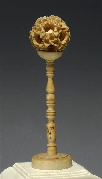 An Antique Chinese Ivory Puzzle Ball and Stand: China, Ca. 1900. Antique ivory set, the multilayer ball pierced with writhing dragons and supported on a tall stand with wide base. 3-1/4"H. Provenance: Ex-Bishop Gallery, Allenspark, CO. Authenticity