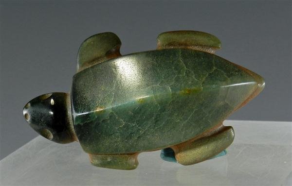 A Han Dynasty Cicada Jade Pendant: China, Beautiful varigated jade pendant carved in the likeness of a cicada; with incised details. In China, the phrase 'to shed off the golden cicada skin'(金蝉脱壳, pinyin: J&