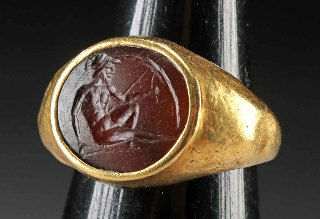 Gold Ring w/ Roman Carnelian Intaglio Warrior & Shield: Roman, Republic Period, ca. 1st century BCE; Western Europe, probably England or France, ca. 19th to early 20th century CE. A beautiful carnelian intaglio that is incised with the image of a right-fac