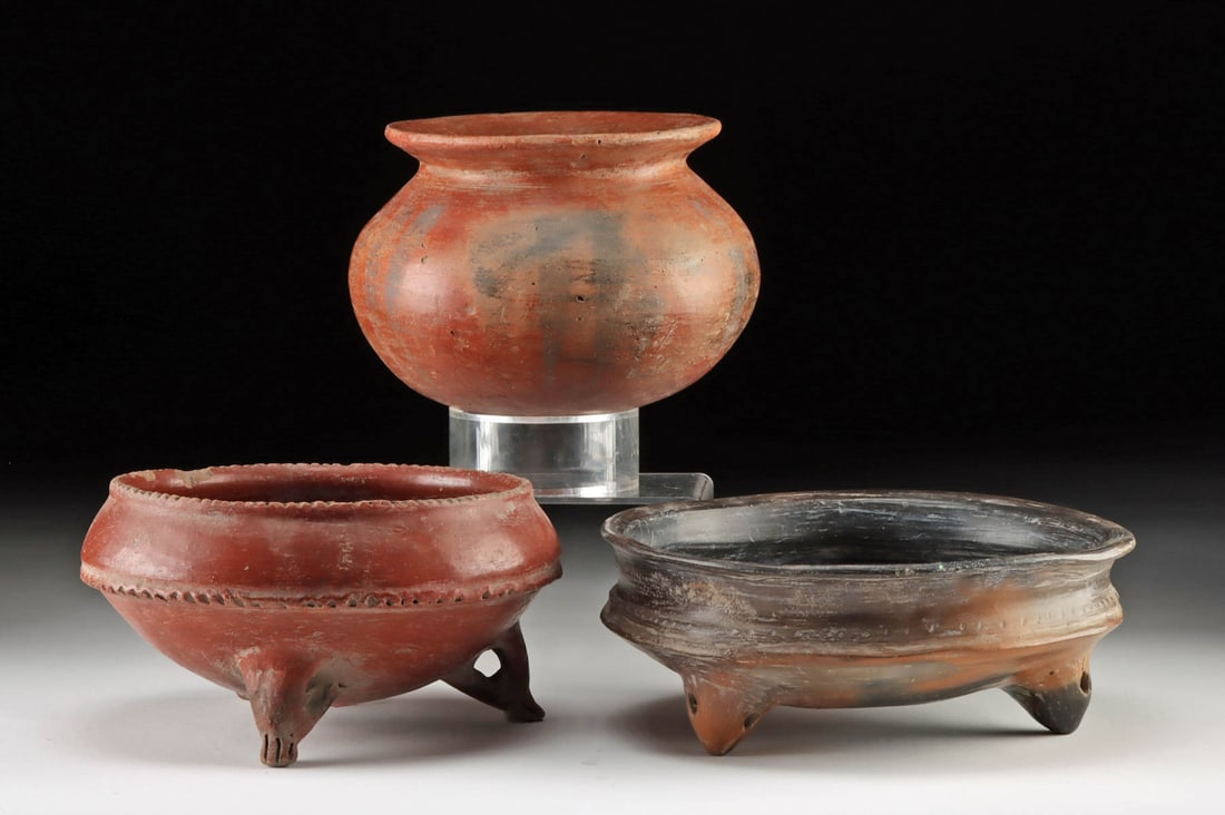 Three Chupicuaro Pottery Vessels - 2 Tripods + 1 Jar: Pre-Columbian, West Mexico, Chupicuaro culture, ca. 500 to 100 BCE. An attractive trio of Chupicuaro pottery vessels: a redware, round-bottomed jar with liberal remains of black-painted stripes, a red