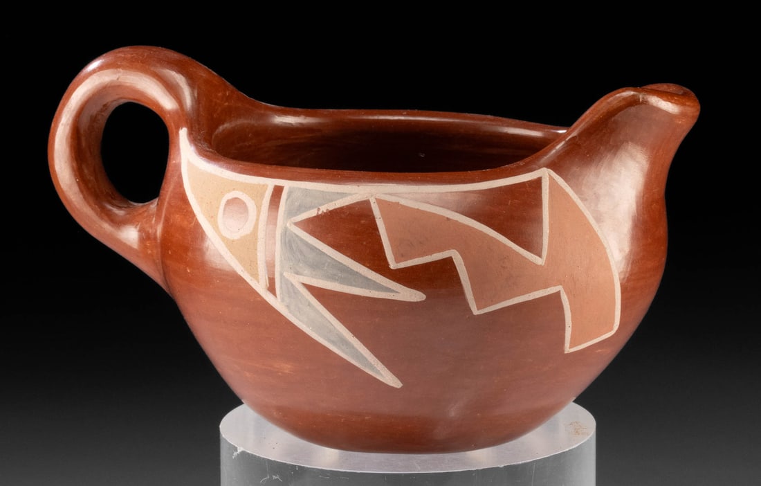 Santa Clara Pueblo Redware Pouring Vessel: Native American, Southwestern United States, New Mexico, Santa Clara Pueblo, ca. mid to late 20th century CE. A redware vessel shaped like a gravy boat with painted matte motifs. The surface is highly