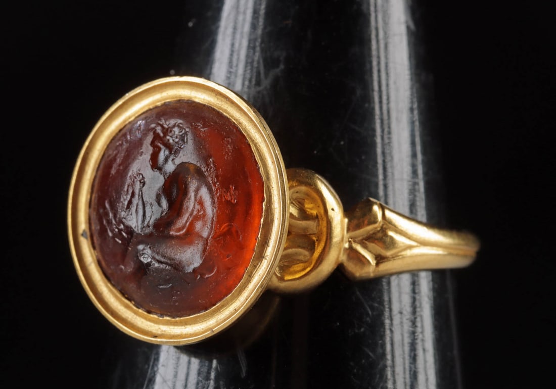 Roman Carnelian Intaglio Nude Satyr (18K+ Gold Ring): Roman, Republic Period, ca. 1st century BCE; Western Europe, probably England or France, ca. 19th to early 20th century CE. A gorgeous carnelian intaglio incised with a left-facing satyr in a seated p
