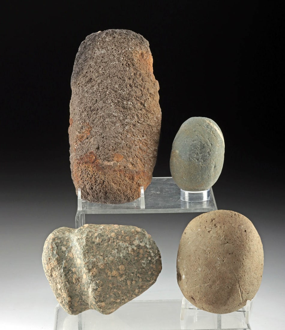 Four Native American Eastern Woodland Stone Tools: Native American, Midwestern to Eastern United States, Eastern Woodland Period, ca. 5000 BCE to 1000 CE. A set of 4 hand-carved tools including 2 hammerstones, a full-groove hand axe, and a gently curv