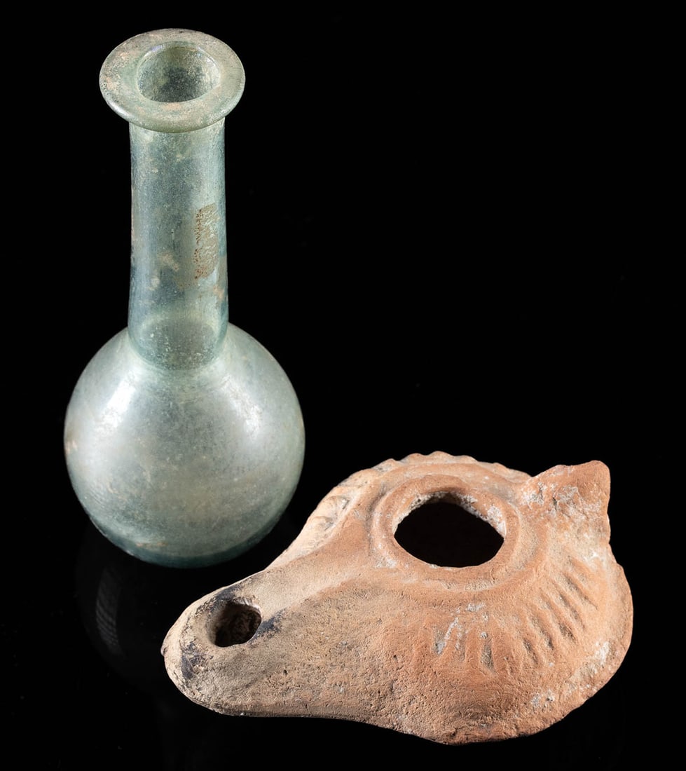 Roman Pottery Oil Lamp & Glass Flask: **Originally Listed At $300** Roman, Imperial Period, ca. 2nd to 4th century CE. A mold-formed pottery oil lamp - with nubbin handle and ribbed side walls - accompanied by a free-blown glass flask of