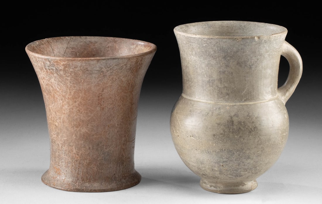 2 Ancient Amlash Grayware & Redware Pottery Vessels: Ancient Central Asia, southern Azerbaijan and northern Iran, Ardabil region, Amlash, ca. 1200 to 800 BCE. A pair of pottery vessels, including a grayware cup or petite pitcher with a handle, and a sim