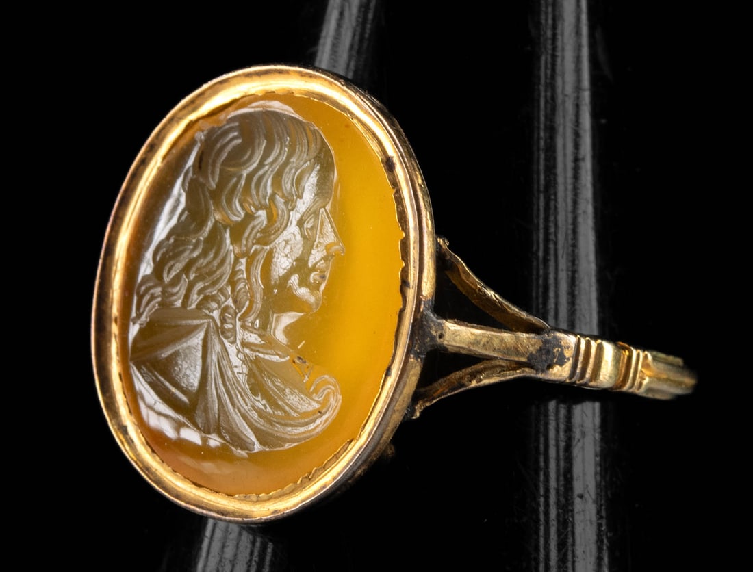 19th C. Carnelian Itaglio Elegant Female (in Gold Ring): Western Europe, probably England or France, ca. 19th century CE. A beautiful gold ring of wearable form featuring a hand-carved carnelian intaglio depicting an elegant, right-facing female bust with a