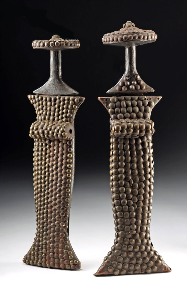 African Konda Iron Short Swords (Konda / Ikakalaka): Central Africa, Democratic Republic of the Congo, Mongo peoples, ca. early to mid-20th century CE. A pair of ceremonial knives, or short swords, known as Konda (also Ikakalaka), featuring broad iron b