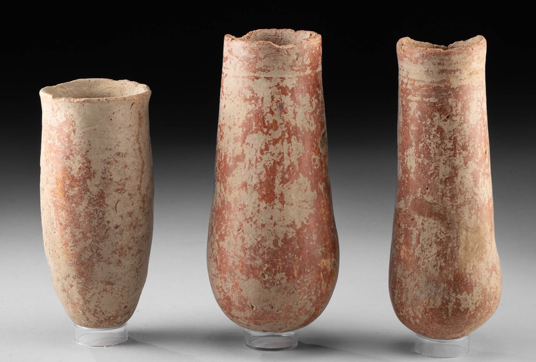 19th C. African Djenne Redware Cylindrical Vessels (3): Western Africa, Mali, Middle Niger Civilization / Djenne, ca. 19th century CE or earlier. A group of three redware vessels, each of slender cylindrical form. Two of the vessels feature rounded bottoms