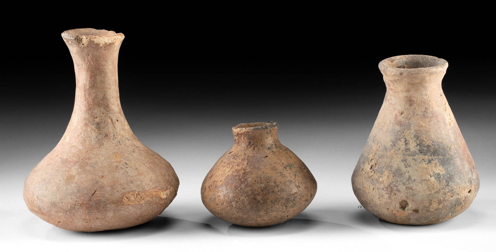 Three African Djenne Redware Pottery Vessels: **Originally Listed At $200** Western Africa, Mali, Middle Niger Civilization / Djenne, ca. 19th century CE or earlier. A group of 3 redware vessels, each with a thick, rounded body. The Middle Niger