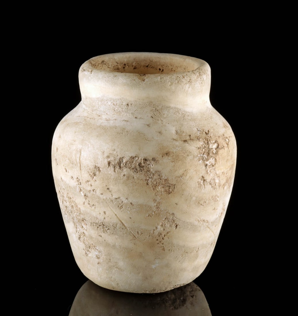 Attractive Egyptian Banded Alabaster Jar: Egypt, New Kingdom to Third Intermediate Period, 18th to 25th Dynasty, ca. 1550 to 664 BCE. Hand-carved alabaster jar exemplifies the refined craftsmanship of ancient Egypt. Its form tapers gracefully