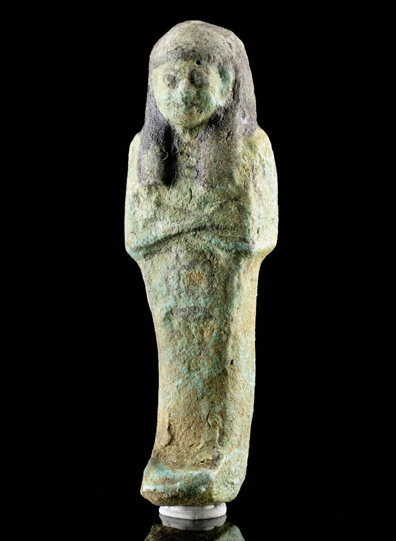 Egyptian New Kingdom Faience Ushabti, TL Tested: Ancient Egypt, New Kingdom period, Dynasties 18th to 20th, ca. 1549 to 1077 BCE. A wonderful faience ushabti enveloped in rich turquoise glaze with black painted details. Standing mummiform with a hoe