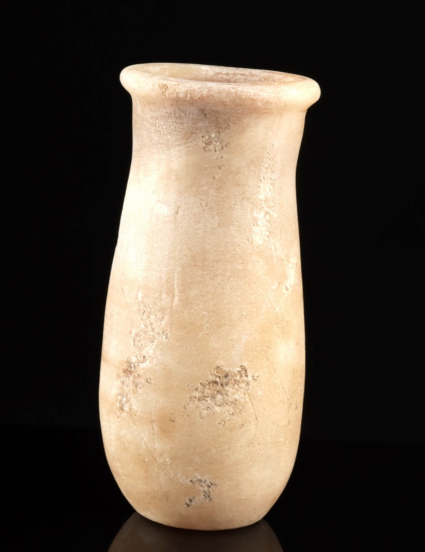 Egyptian Middle Kingdom Banded Alabaster Flask: Ancient Egypt, Middle Kingdom, ca. 2040 to 1802 BCE. A delightful alabaster flask with a long, slightly teardrop-shaped body and a narrow neck that gently swells before flaring out to a flat rim. Boas