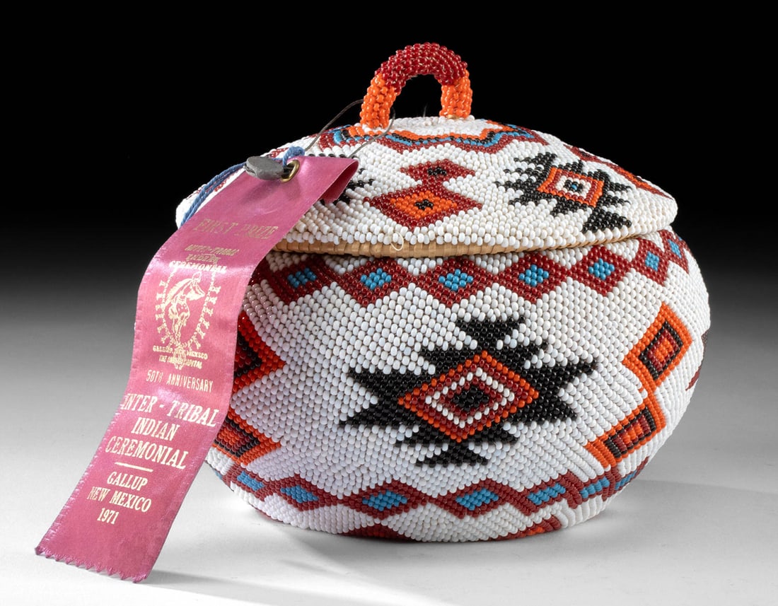 Superb Washoe Beaded Basket, 1971 Gallup Intertribal Winner!: Native American, Western United States, Nevada, Washoe, ca. 1971 CE. A beautiful basket with a lid, encased in beadwork using a netted stitching technique. As pictured, a first-place ribbon is attache