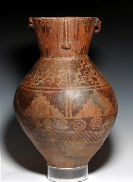A Huge Narino Pottery Storage Jar: Pre-Columbian, Colombia, Ca 1200 CE. Large anthropomorphic storage jar from the border area of Colombia / Ecuador. Decorated in brown against a deep red background with chevron pattern at lowest level