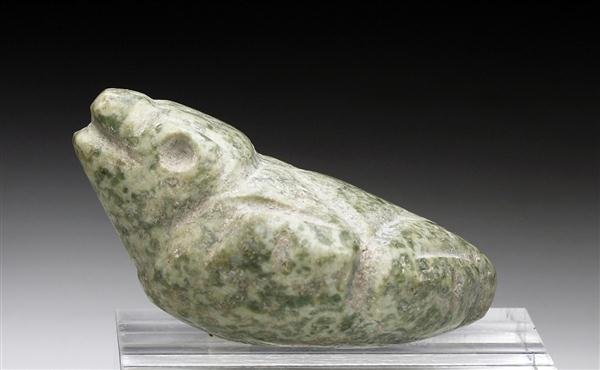 A Mezcala Guerrero Stone Frog: Pre-Columbian, Mexico, Mezcala, Ca 500 to 200 BCE. Of speckled jadeite in the form of a frog resting on all fours, head extended looking as if he is ready to leap at an insect. Features string cut or 