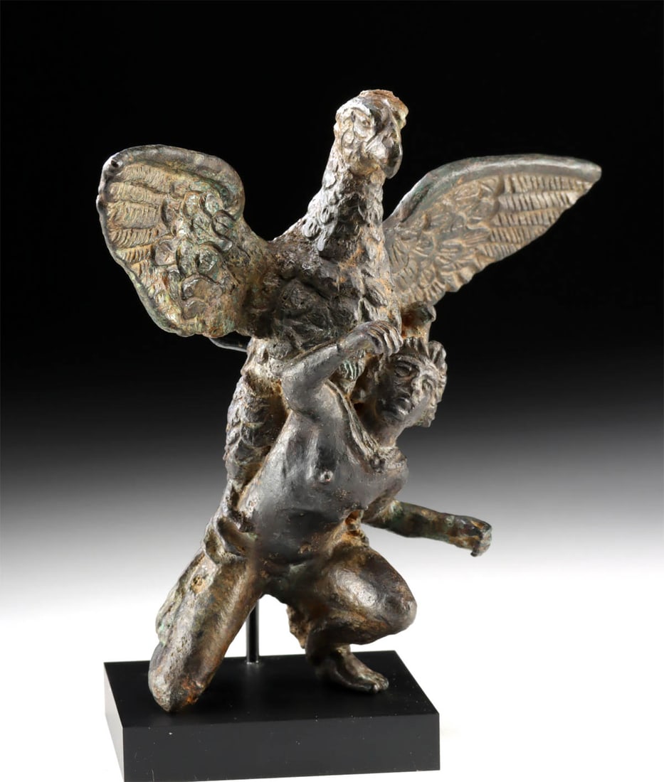 Roman Bronze Ganymede Grasped by Zeus as an Eagle: Roman, Imperial period, ca. 2nd to 3rd century CE. An evocative leaded bronze sculpture depicting Jupiter (Greek Zeus) in the form of an eagle swooping down to lift up the youthful, crouching Ganymede