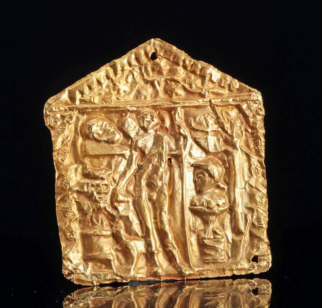 Roman Gold Repoussé Appliqué of a Deity in Aedicula: Roman, Republic to early Imperial period, ca. 1st century BCE to 1st century CE. A stunning, nearly 24-karat gold repousse applique an aedicula or petite shrine featuring a central nude male youth, po