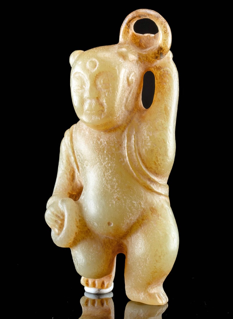 Rare Eastern Han Dynasty Nephrite Jade Acrobat with Rings: East Asia, China, Eastern Han Dynasty, ca. 25 BCE to 220 CE. This rare nephrite jade carving features a standing figure, possibly an acrobat, holding two circlar rings, one above his head the other at