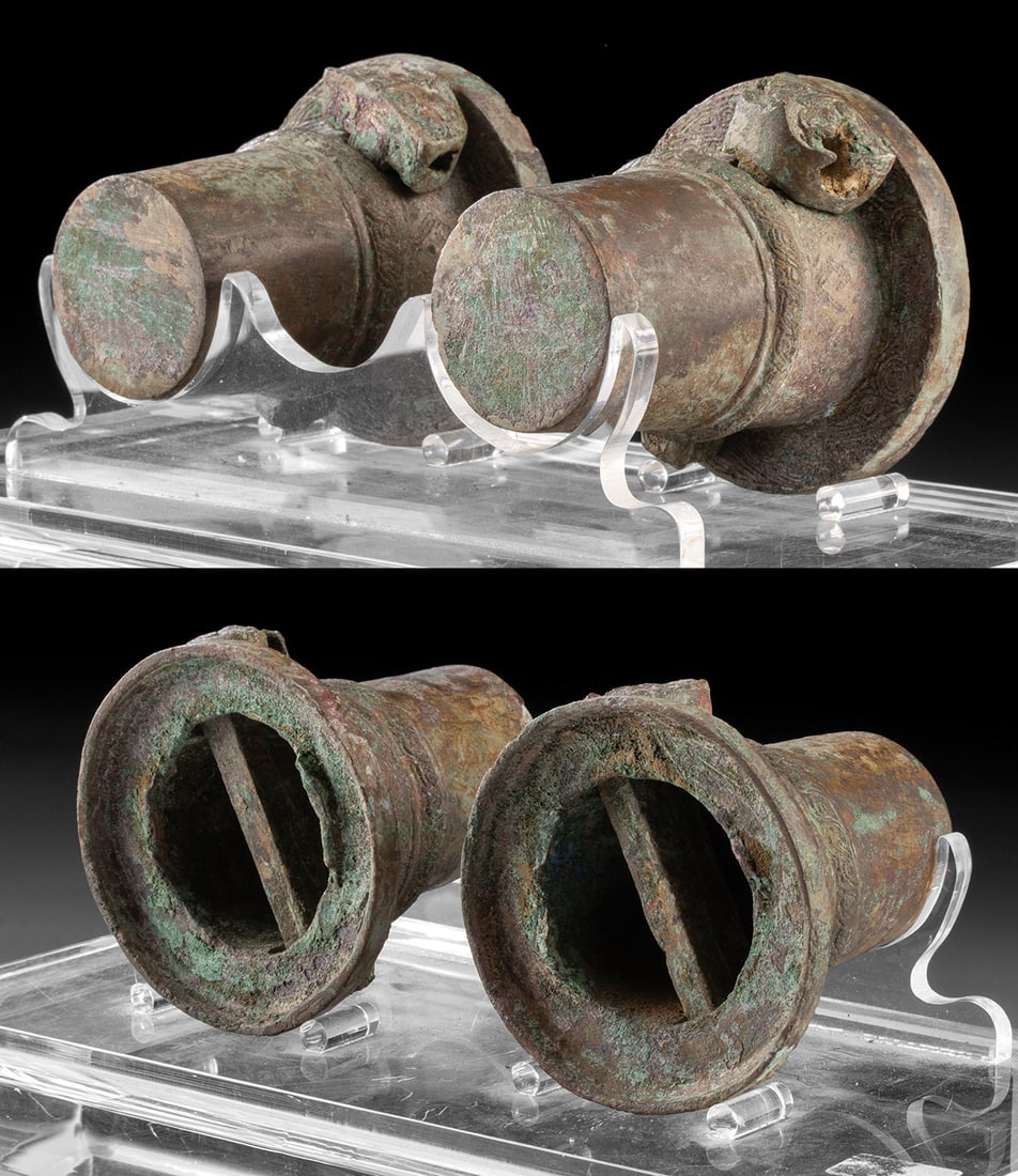 Warring States / Han Dynasty Chariot Hubs Taotie Motifs (pr): East Asia, China, Warring States to Han dynasty, ca. 475 BCE to 206 CE. A matching pair of leaded bronze axle hubs from chariot wheels, adorned with incised and stippled bands of scrolling motifs. The