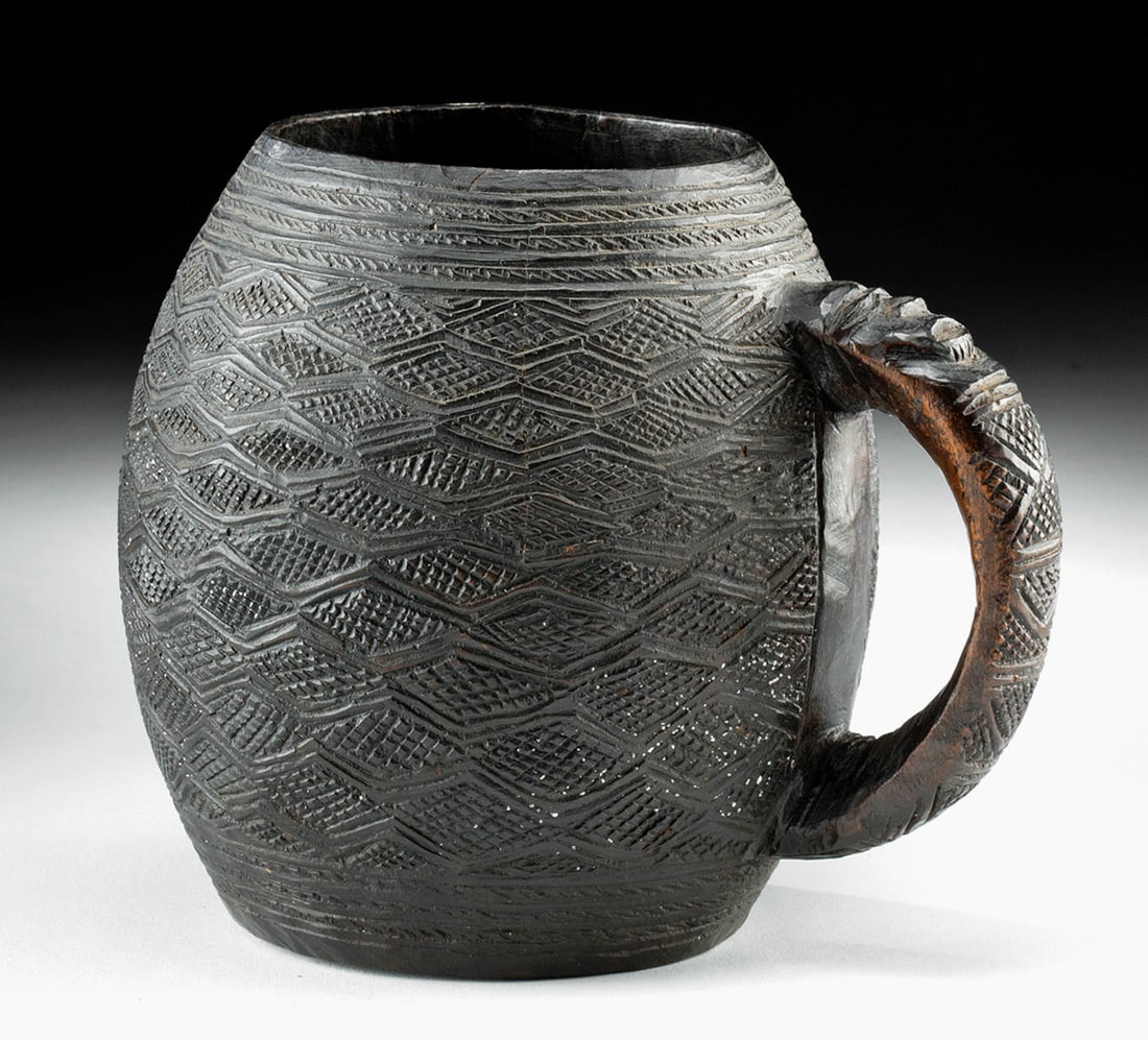 19th C. African Kuba Wood Palm Wine Cup: **Originally Listed At $200** Central Africa, Democratic Republic of the Congo, Kuba peoples, ca. late 19th to early 20th CE. A large hand-carved wooden palm wine cup featuring a handle adorned with a
