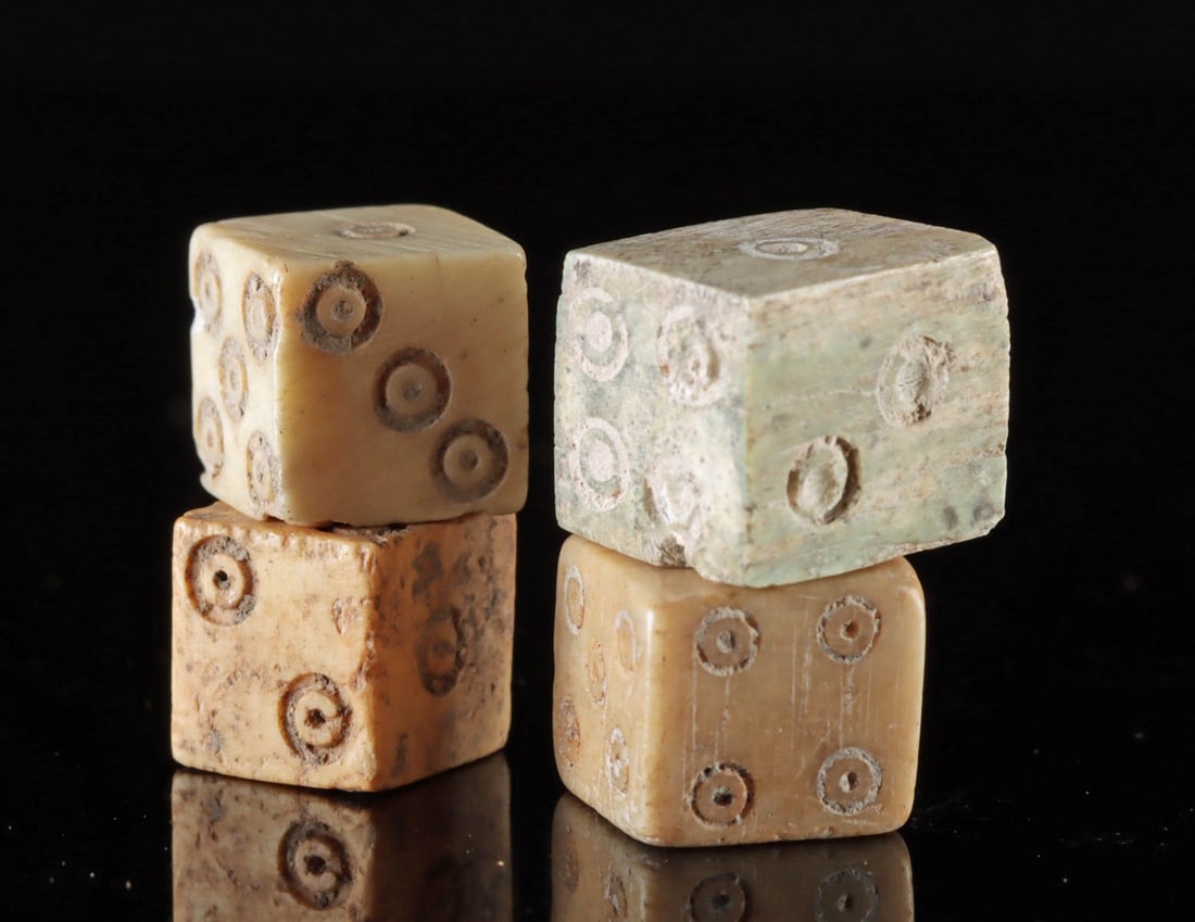 Ancient Roman Gaming Dice, Hand-Carved from Bone (4): Roman, Imperial Period, ca. 1st to 3rd century CE. A fantastic set of four hand-carved gaming dice, crafted from the bone of a cow or another ungulate. Each die features planar sides adorned with inci