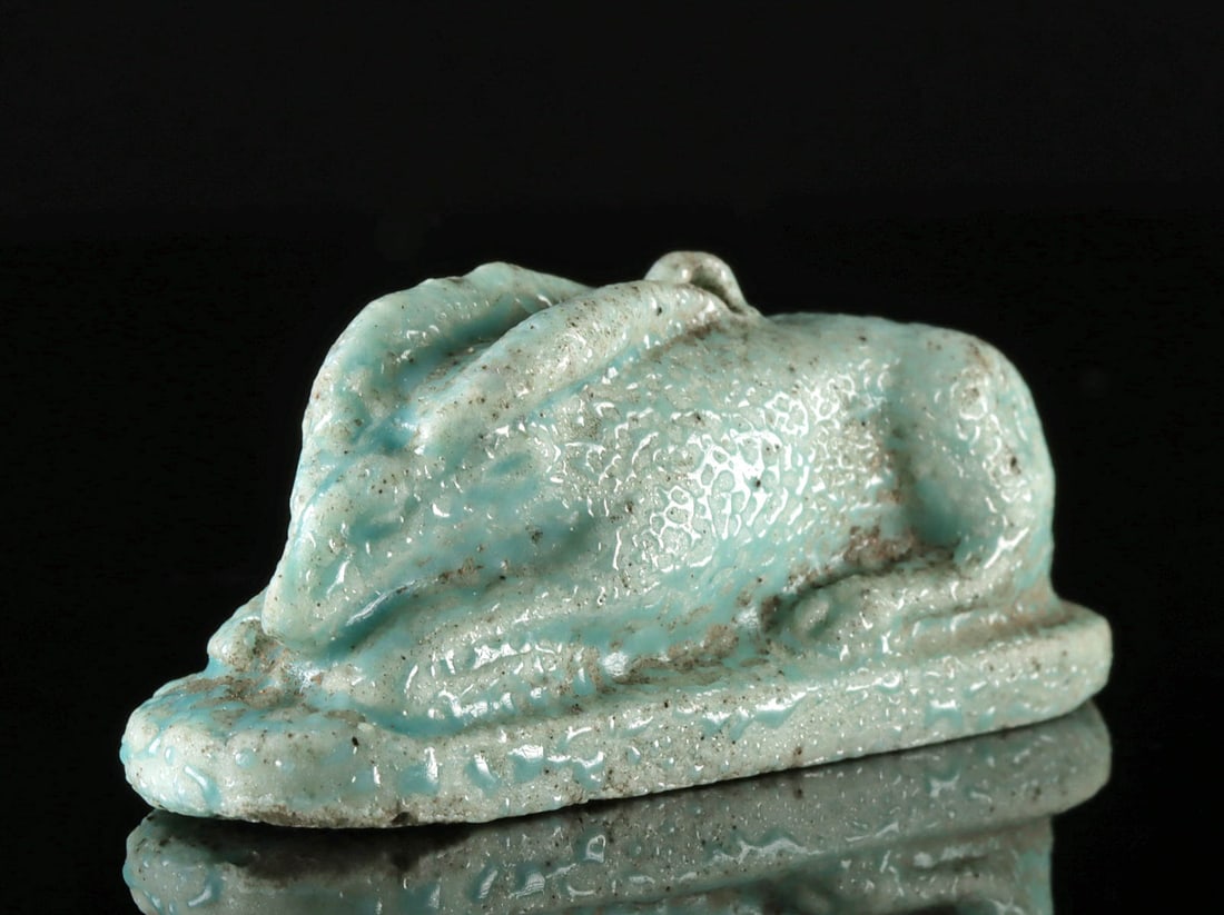 Egyptian Faience Amulet of Recumbent Scimitar Oryx (Antelope): Egypt, New Kingdom to Late Period, 18th to 31st Dynasty, ca. 1549 to 32 BCE. A remarkable faience amulet in the rare form of a recumbent Egyptian antelope or scimitar oryx on an integral plinth with a