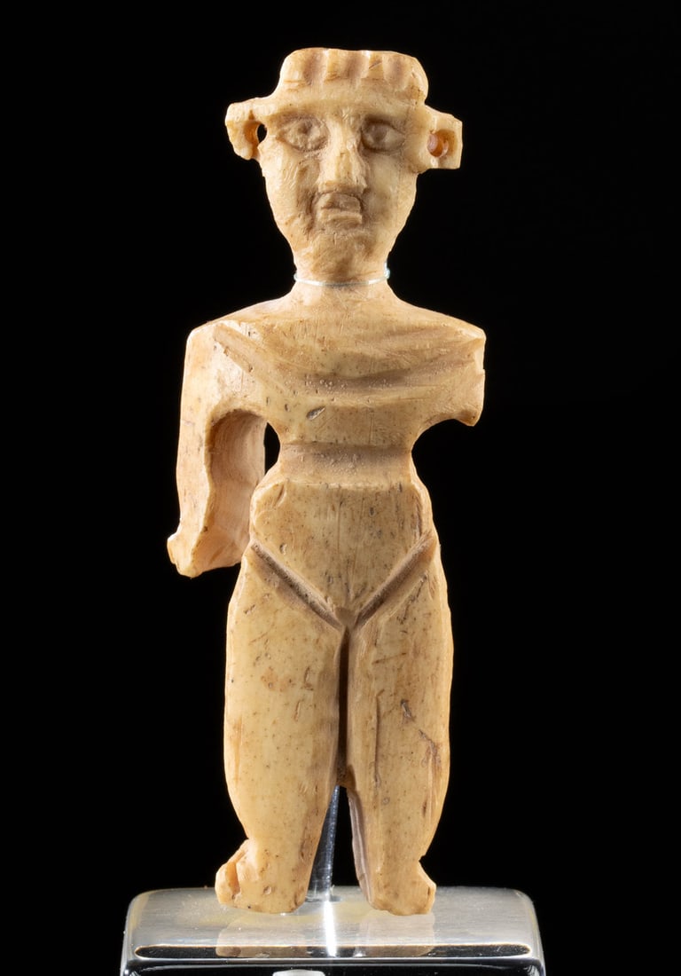6th C. Byzantine Bone Doll Depicting Abstract Human Form: Ancient Near East, Byzantine Empire, ca. 6th to 9th century CE. A fascinating doll carved from the bone of an ungulate to present a minimalist, abstract form with delineated legs and incised features.