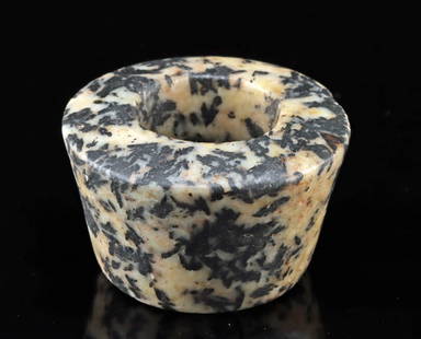 Egyptian / Nubian Meroitic Granodiorite Archer’s Thumb Ring: Ancient Egypt / Lower Nubia (Sudan), Meroitic Period, ca. 300 BCE to 350 CE. A finely carved archer’s ring, sculpted from porphyry or a dark, mottled granodiorite-tonalite stone. The ring features a