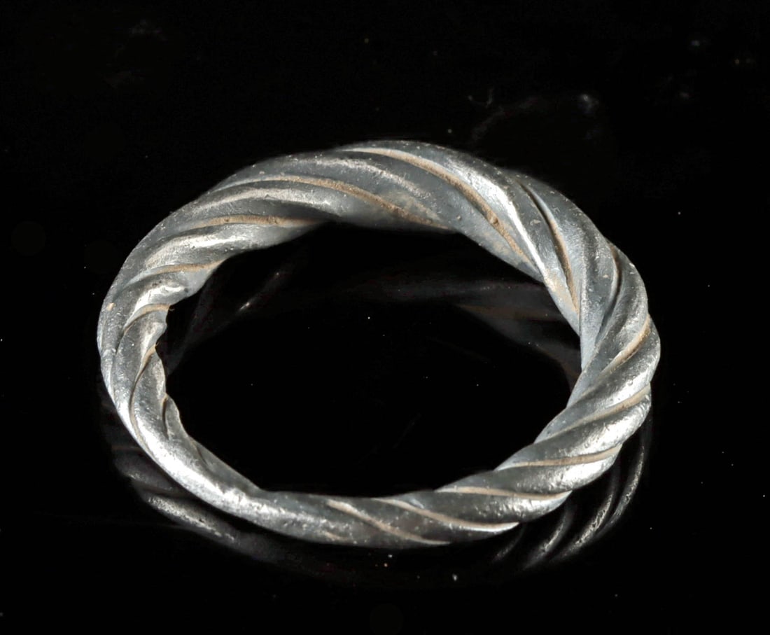 11th C. Viking Twisted Silver Ring: Northern Europe, Viking/Norse culture, ca. 1000 CE. A stunning and wearable ring comprised of a single, twisted band of over 98% silver. Its swiveled body tapers at one side, conveying a minimalist ye