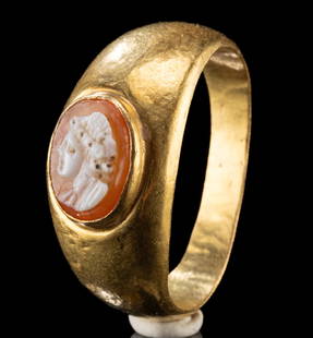 Roman Gold Ring w/ Agate Camo of Female Bust: Roman, Imperial period, ca. 1st to 3rd century CE. A beautiful agate cameo featuring the bust of a female, perhaps an empress, mounted on a thick ring band of over 21 karat gold. Ovoid in form, the ca