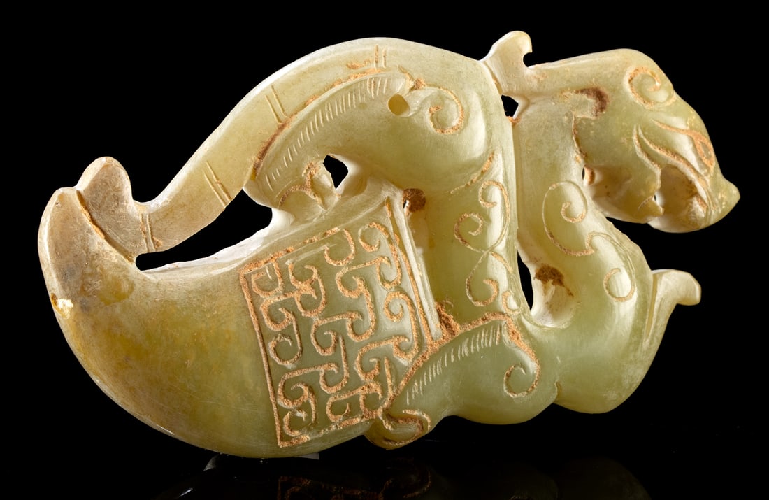 Ancient Chinese Han Greenstone Pixiu Winged Lion Amulet: East Asia, China, Western Han Dynasty, 206 BCE to 9 CE. A finely carved stone amulet or pendant in a flattened form, depicting a mythical Pixiu - a powerful dragon-lion hybrid - perched atop a horn sh