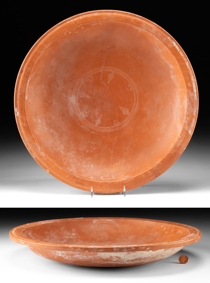 Large Roman North African Terra Sigillata Stamped Plate: Roman, North Africa, Imperial period, Carthage, ca. 3rd to 4th century CE. A charming yet sizable, wheel-thrown redware pottery dish with a low, squat form and a flat base. Its broad walls rise to a s