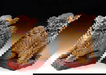 Matched Pair of 19th C. Chinese Qing Gilt Wood Fu Lions: East Asia, China, Qing Dynasty, ca. 19th century CE. A striking pair of carved wooden Foo dogs, powerful symbols also known as temple lions, exudes a commanding presence. The rich texture of their dee