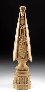 19th C. Colonial Portuguese Brazilian Wood Santo: Portuguese Colonial, Brazil, ca. 19th century CE. A pretty wooden santo of Our Lady of Aparecida depicted crowned and veiled with hands clasped as she stands atop a pillar, all enveloped in pale, beig