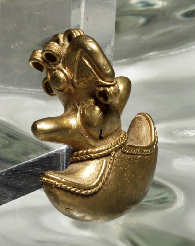 A Costa Rican Tumbaga Bird Pendant: Pre-Columbian, west coast of Central America, Costa Rica / Panama, ca. 700-1500 CE. A depletion-gilded tumbaga bird, looking much like a toucan, with beaded design/band on front. 1-3/4"L, 17.1g. With 