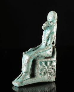 Egyptian Faience Amulet - Seated Sekhmet w/ Papyrus Scepter: Ancient Egypt, Late Dynastic to Ptolemaic Period, ca. 664 to 30 BCE. A mold-made faience amulet depicting Sekhmet, the lioness-headed goddess of war, destruction, and healing, seated upon a throne. Sh